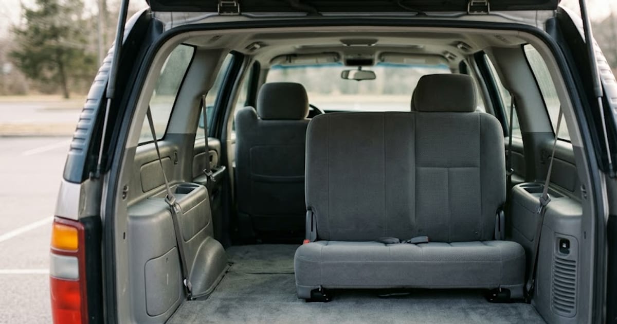 The third-row seats of a three-row SUV seen from the open tailgate
