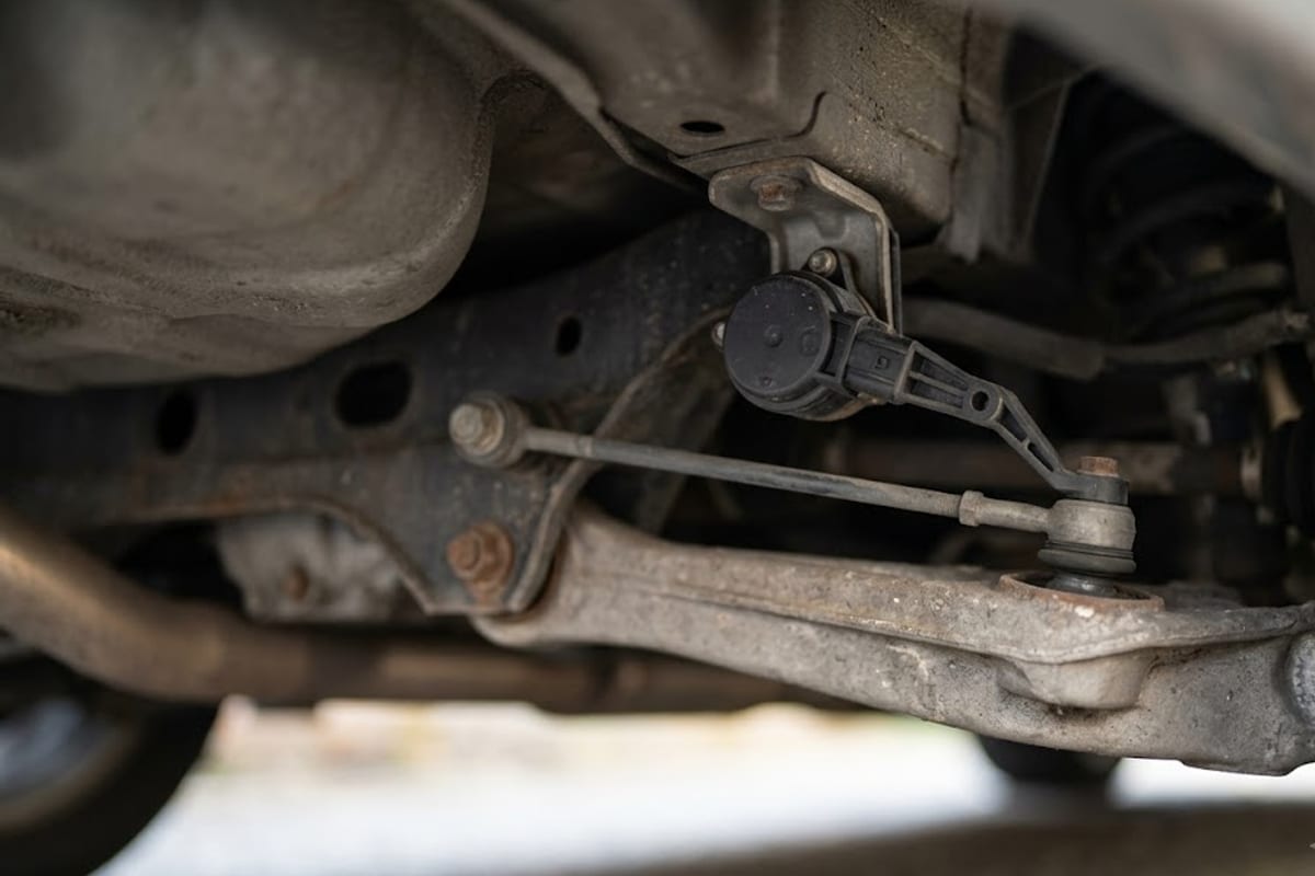 A ride height sensor linked to the rear suspension arm