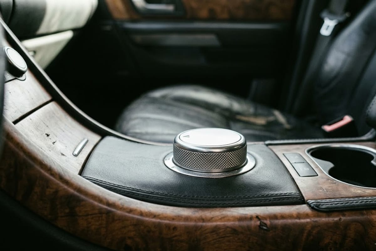 A rotary gear selector dial in a luxury SUV console